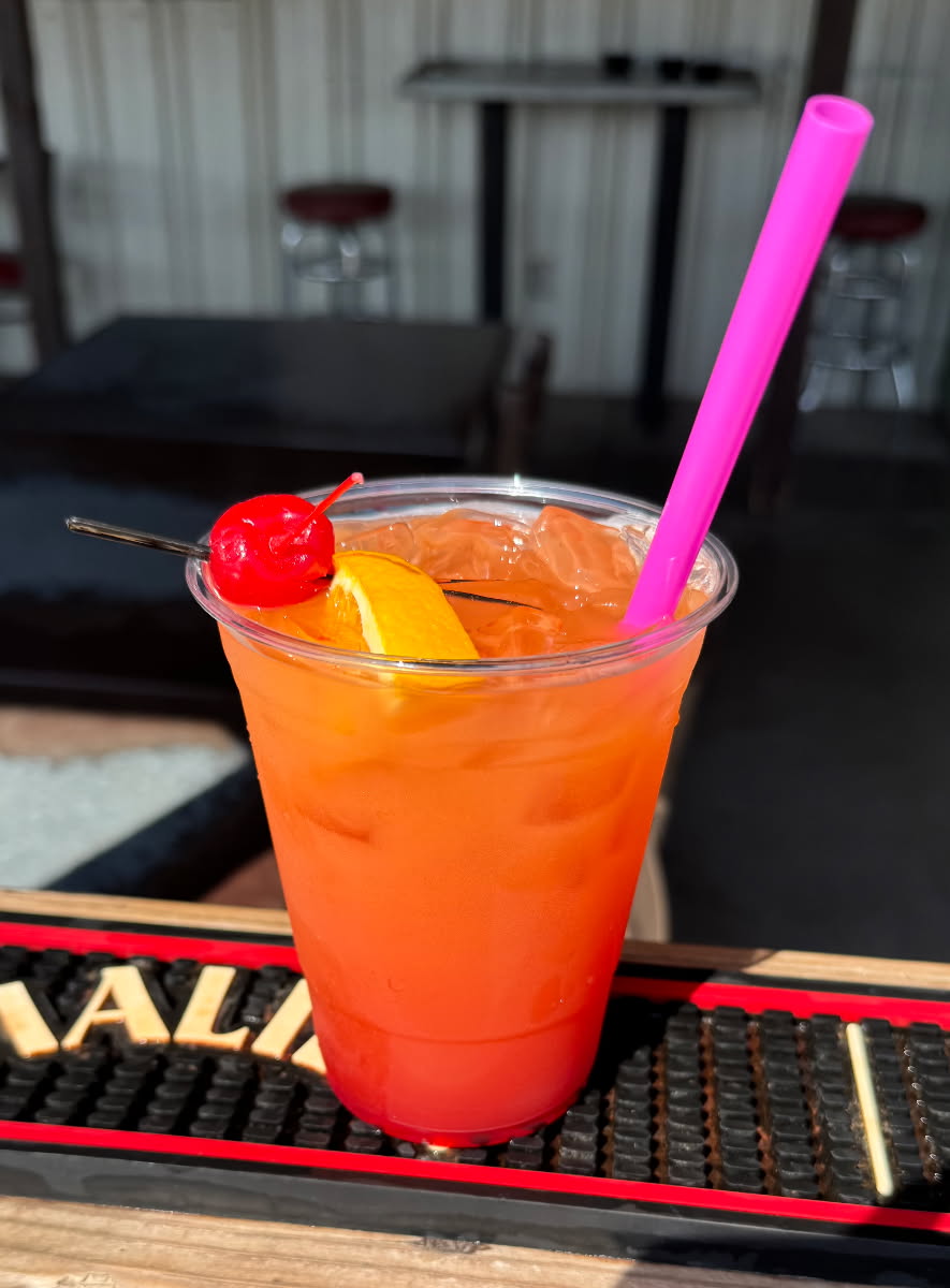 red drink Fisher's Landing Bloody Mary in a plastic cup